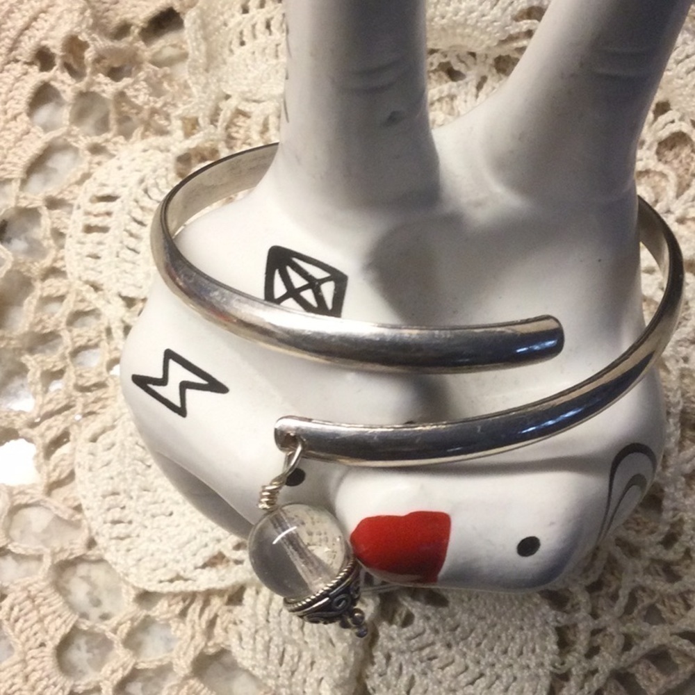 Silver bangle with charm detail